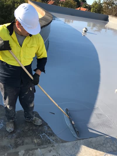 Sheet and torch-on membrane waterproofing being applied to a commercial rooftop